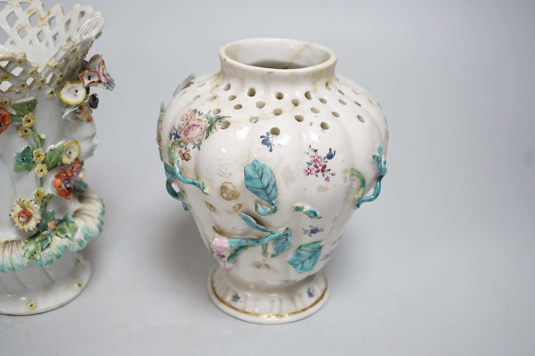 An 18th century Chelsea pot pourri vase, red anchor period, encrusted and painted with leaves and flowers and a Bow frill vase with mask heads encrusted with flowers. Tallest 16.5cm